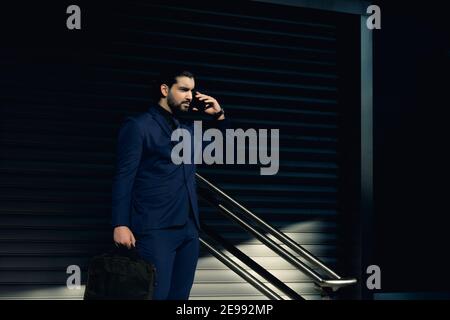 Young businessman walking down the street Stock Photo