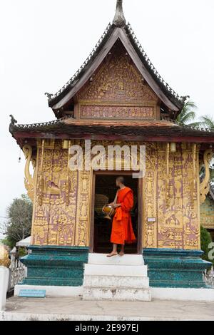Luang Prabang, Laos Intricate mosaics cover the pink walls of a temple of of Wat Xieng Thong. Stock Photo