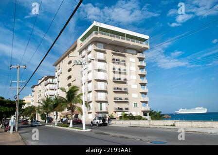 The morning view of San Miguel resort town main street with an arriving cruise ship in a background (Cozumel, Mexico). Stock Photo