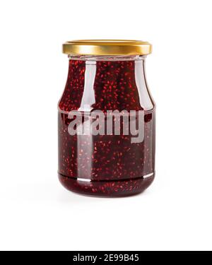 Delicious sweet raspberry jam in a glass jar with golden lid isolated on white background. Traditional homemade red berry jelly, marmalade,  confiture Stock Photo