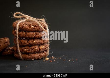 Stack of homemade sweet chocolate cookies on black background. Stock Photo