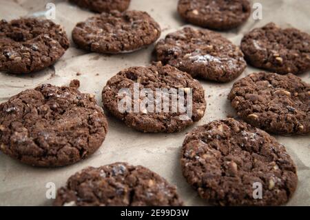 Fresh homemade sweet chocolate cookies on baking paper.
