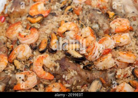 Delicious spanish paella with chicken and seafood. This image may be used as a background. Close-up. Stock Photo