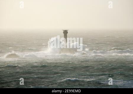 Waves Crashing against Longships Lighthouse in Stormy Seas. Cornwall. England. UK.