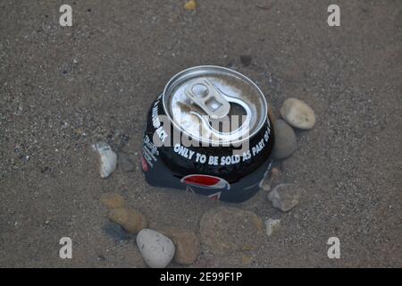 Soft Drinks Can Left On A Beach - Pushed Into The Sand - Rubbish - Litter in Sand - Pebbles / Stones / Sand - Waste Pollution - Yorkshire - UK Stock Photo