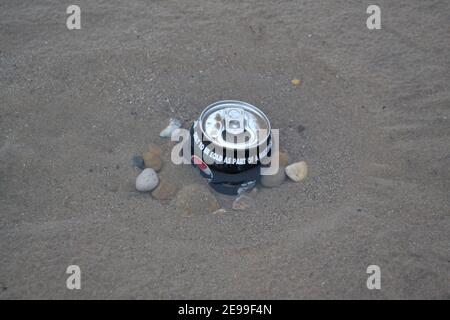 Soft Drinks Can Left On A Beach - Pushed Into The Sand - Rubbish - Litter in Sand - Pebbles / Stones / Sand - Waste Pollution - Yorkshire - UK Stock Photo