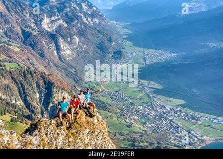 men fellowship take picture with breathtaking view from zuestoll churfirsten into the valley of wallenstadt. Autumn in Switzerland Stock Photo