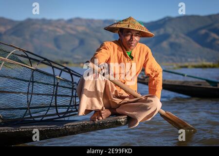Inle lake, Myanmar - December 2019: fisherman rest on boat Stock Photo