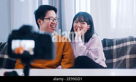 Young asian couple having fun while recording video message for family. High quality photo Stock Photo