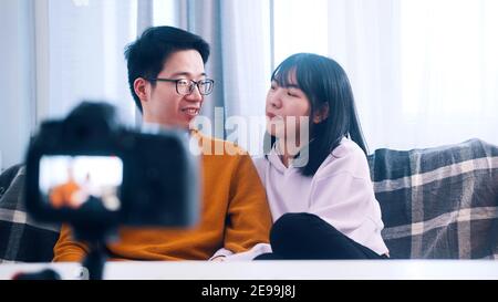 Young asian couple having fun while recording video message for family. High quality photo Stock Photo