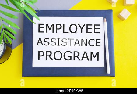 Employee Assistance Program business text written on white paper above Notebook Freelance concept. yellow background. Stock Photo
