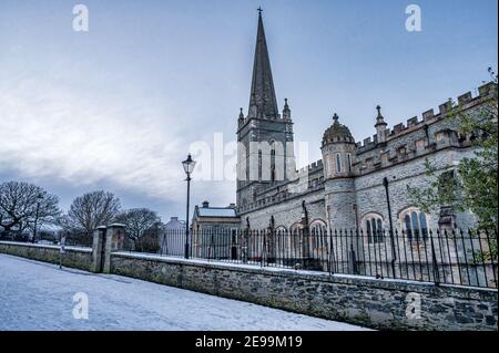 Derry, Norther Ireland- Jan 23, 2021: St Columb's Cathedral in the Derry walls in winter covered in snow