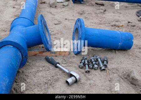 Cast metal pipe connection with flange and tools. Stock Photo