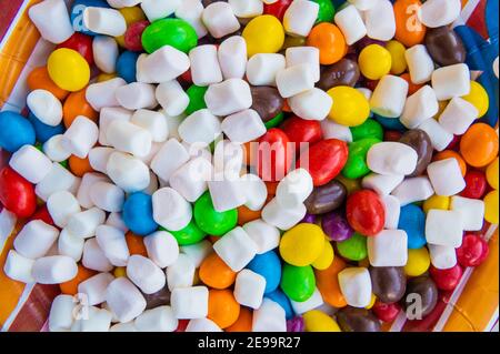 Mix of colorful Candies, delights and marshmallow on the plate. The sugar feast, any celebrations or children's party. Stock Photo