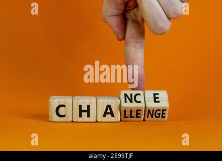 Challenge or chance symbol. Businessman turns cubes and changes the word 'challenge' to 'chance'. Beautiful orange background, copy space. Business an Stock Photo