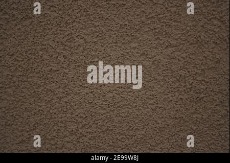 Full-frame seamless texture of a monochromatic beige spackled wall. Stock Photo