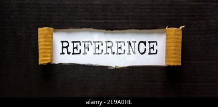 Reference symbol. The word 'reference' appearing behind torn black paper. Beautiful background. Business and reference concept. Stock Photo