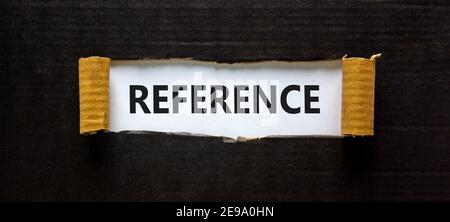 Reference symbol. The word 'reference' appearing behind torn black paper. Beautiful background. Business and reference concept. Stock Photo