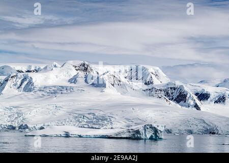 Snow-covered mountains, glaciers, and icebergs in Lindblad Cove, Charcot Bay, Trinity Peninsula, Antarctica. Stock Photo