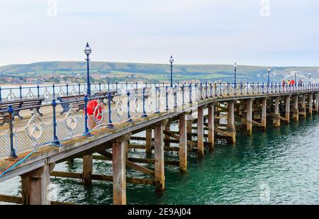 The historic Victorian pier in Swanage Bay at Swanage, Isle of Purbeck on the Jurassic Coast, Dorset, south-west England Stock Photo