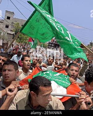 Palestinians carry the body of Anwar Abu Sela'a, during his funeral in Jabalia, Northern Gaza Strip, Palestine, on June 8, 2006, one day after he was killed by Israeli tanks opening fire from across the border. Photo by Mohamed Atta/ABACAPRESS.COM Stock Photo