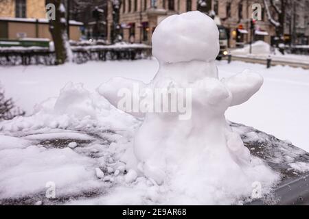 Snowman, snow woman molded from snow. Snowy winter concept. High quality photo Stock Photo