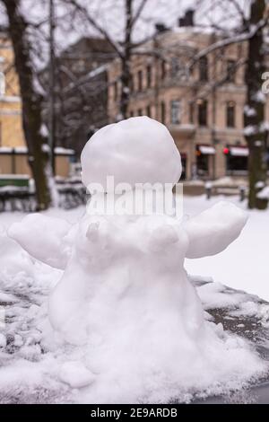 Snowman, snow woman molded from snow. Snowy winter concept. High quality photo Stock Photo