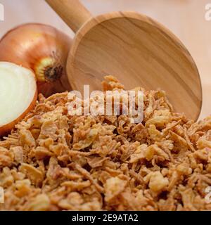 Dried fried onions on a wooden spoon Stock Photo