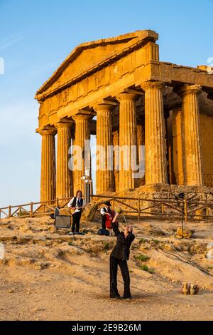Artists perform after dusk at Concordia Temple in a summer sunny morning Stock Photo