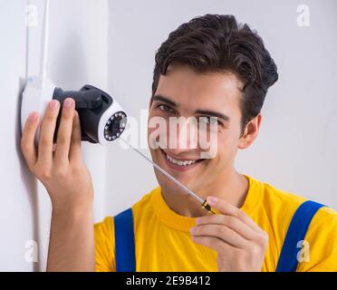 The contractor installing surveillance cctv cameras in office Stock Photo