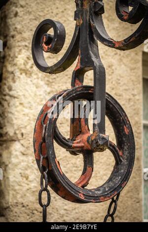 An old metal pulley and the ironwork mechanism it is part of Stock Photo