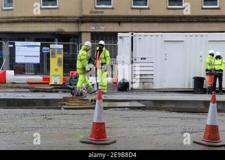 Tramline Construction Workers in Hi Vis Clothes on Leith Walk in Edinburgh Stock Photo