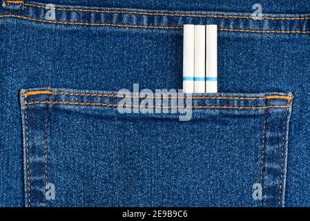 slim cigarettes in the jeans pocket on back side Stock Photo
