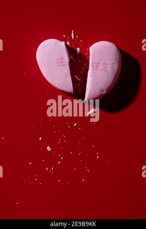 A pink broken candy conversation heart with 'Be True' printed on it Stock Photo