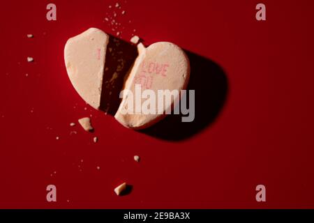 A broken candy conversation heart with 'I Love You' printed on it Stock Photo