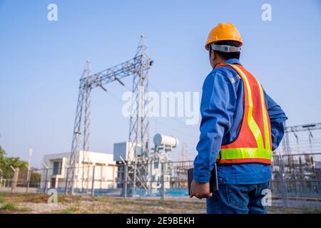 electric engineer check the transmission station. Stock Photo