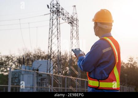 electric engineer check the transmission station, Concept of electric power safety. Stock Photo