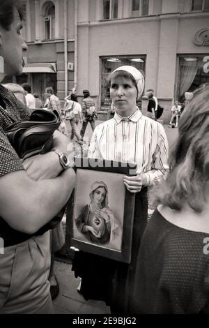 Woman in Faith with Portraits of Saints.Arbat Street, 80s-90s, Moscow, capital; Russia, Stock Photo