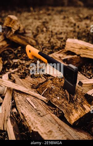 Hatchet stuck in log of fire wood Stock Photo