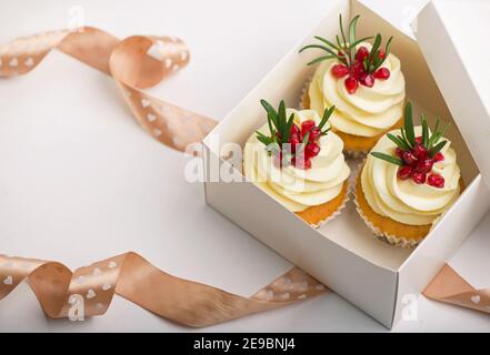 Valentines cupcakes with vanilla in a box on a white background with ribbon Stock Photo