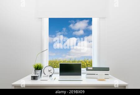 Contemporary home office desk facing stylish window Stock Photo