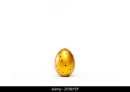 Minimal easter card. One easter trendy golden decorated egg on white background. Copy space for text Stock Photo