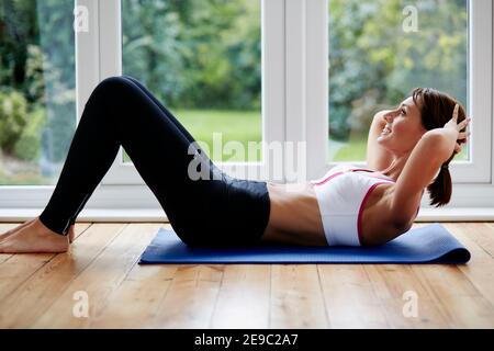 Woman working out at home Stock Photo