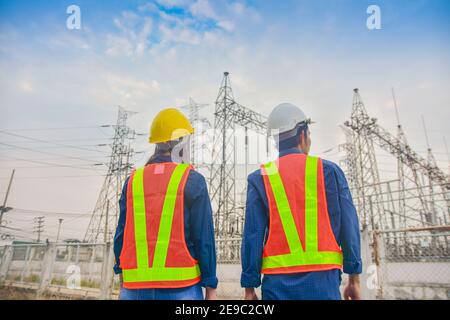 Asian Engineer Man and Women working on site power plant electric system to safety work Stock Photo