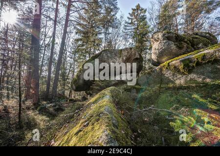 Ancient weathered megalithic granite rock formation with cave and breakthrough in Bavarian forest near Thurmansbang, Germany Stock Photo