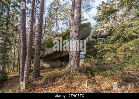 Ancient weathered megalithic granite rock formation with cave and breakthrough in Bavarian forest near Thurmansbang, Germany Stock Photo