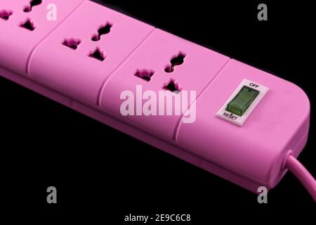 Closeup picture of a pink outlet isolated on black. Electric Power Line on balck background Stock Photo