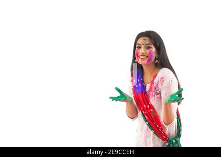 A YOUNG WOMAN WITH GULAL ALL OVER POSING IN FRONT OF CAMERA Stock Photo