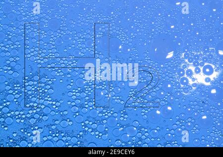 hydrogen h2 letters in a blue fluid with many circles from oil Stock Photo