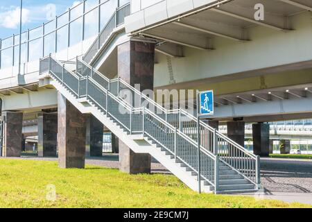 Pedestrian crossing over the bridge over the road. The sign of the transition near the bridge for the safety of pedestrians Stock Photo